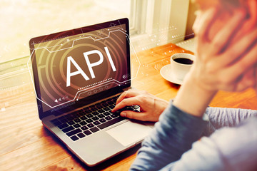 API concept with man using a laptop computer