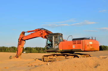 Canvas Print - Excavator on the top of an open industrial sand pit where mining operations are carried out