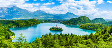 Beautiful Landscape Of Lake Bled The Church Island In The Middle And The Castle In The Background Of White Clouded Sky From Ojstrica Viewpoint In Bled, Slovenia