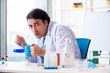 © Elnur - Young male chemist working in the lab