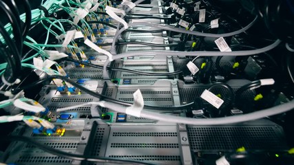 Server computers with many wires at a data center.