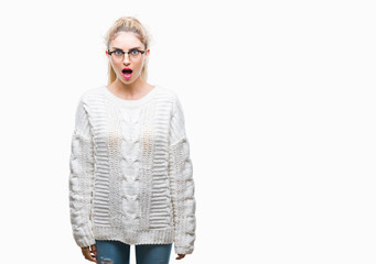 Canvas Print - Young beautiful blonde woman wearing glasses over isolated background afraid and shocked with surprise expression, fear and excited face.