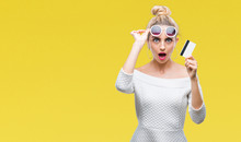 Young Beautiful Blonde Woman Holding Credit Card Over Isolated Background Scared In Shock With A Surprise Face, Afraid And Excited With Fear Expression