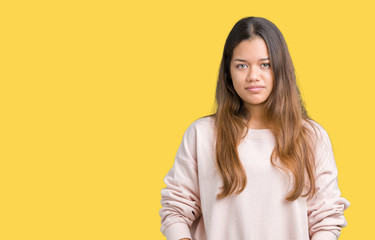 Sticker - Young beautiful brunette woman wearing pink sweatshirt over isolated background with serious expression on face. Simple and natural looking at the camera.