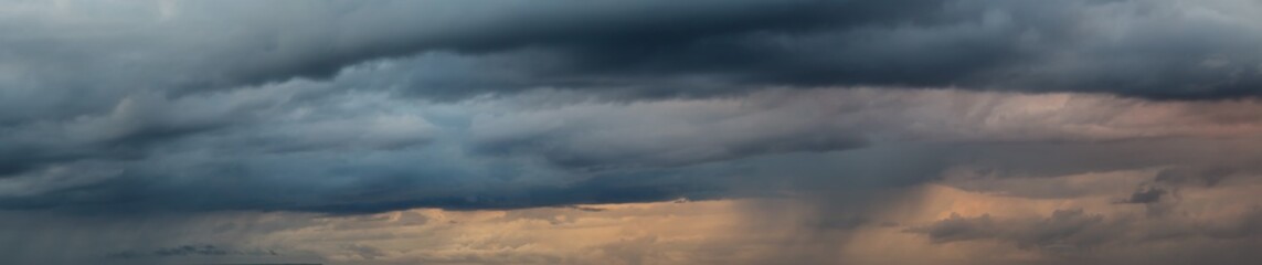 Wall Mural - Dramatic Panoramic View of a cloudscape during a dark, rainy and colorful morning sunrise. Taken over Beach Ancon in Trinidad, Cuba.