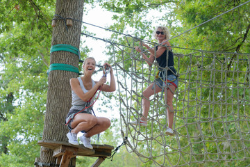 happy women enjoying activity in a climbing adventure park