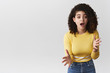 © Cookie Studio - Oh my god spill tea. Amused thrilled outgoing young nervous girl retelling awesome rumour gesturing excited talking warn friend be careful standing intense white background have conversation