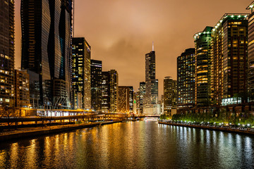 Wall Mural - Chicago city illuminated buildings in the evening. Reflections on the river canal