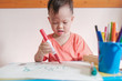 © yAOinLoVE - Cute little Asian 2 - 3 years old young toddler boy child drawing, scribbling with pen color markers, kid write in living room at home,Creative play for toddlers, fine motor skills development concept