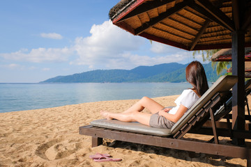 Beautiful young asian woman leisure around the beach sea and ocean with blue sky for vacation travel image. Relaxing image of beautiful girl at holiday island.