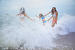 © stockphoto mania - three woman happiness emotion with splashing sea beach wave