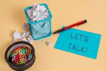 Text sign showing Let S Is Talk. Business photo text suggesting in the beginning of a conversation on the topic crumpled paper trash and stationary with note paper placed in the trash can