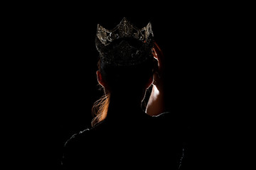 Portrait Silhouette Shadow Back Rim Light of Miss Pageant Beauty Queen Contest Silver Diamond Crown wave hand express feeling smile, studio lighting dark black background, turn front face to camera