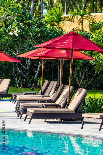 Beautiful Umbrella And Chair Around Outdoor Swimming Pool In