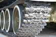 A tank of the second world war. Caterpillar armored closeup shot. Black track link and large rubber-coated rollers. Chassis tank. Tank tracks.