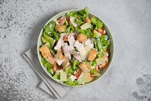 Caesar Salad With Chicken, Parmesan And Wheat Croutons On A Vintage Grey Background. Light Diet Dinner.