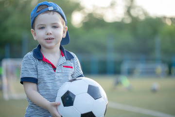 little   boy in the playing field In Football Team. Sport.