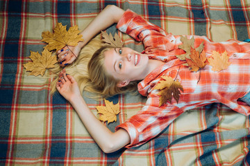 Wall Mural - Beautiful sensual blonde playing with leaves. Fashion portrait of beautiful sensual woman. Girl in autumn in seasonal clothes whith golden leaf. Autumn girl getting ready for autumn sale. Leaf fall.