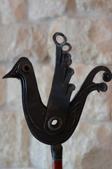 Forged bird on the stone wall background