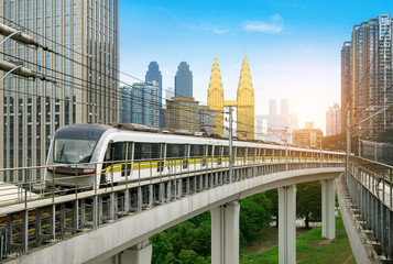 Wall Mural - the light rail train shuttles through the city.