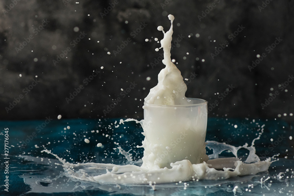 Splash of milk in a glass, motion of liquid - obrazy, fototapety, plakaty 