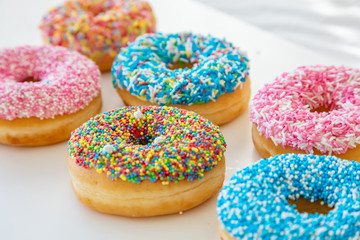 Wall Mural - Doughnuts assorted on white. Close up view