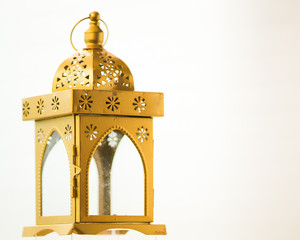 Traditional fanoos or an Arabic decorative lantern on white background. Eid celebration objects and background.