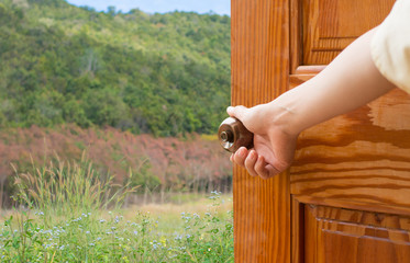 Wall Mural - Women hand open door knob or opening the door,grand opening,Close up hand open door.