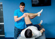 © romaset - Rehabilitation therapy. Physiotherapist working with young male patient in the rehabilitation center