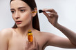 © Yakobchuk Olena - Beautiful young woman with perfect skin applying vitamin serum on her face
