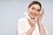 © Yakobchuk Olena - Joyful young woman in white bathrobe holding pore cleansing brush