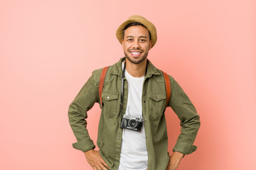 Young filipino traveler man confident keeping hands on hips.