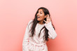 © Asier - Young indian woman wearing pajama trying to listening a gossip.