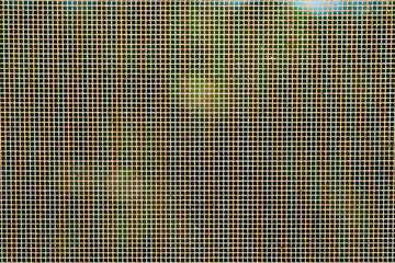 Grid on the window against mosquitoes in sunlight. Abstract background