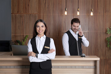 Poster - Receptionist at desk with colleague in lobby