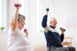 © Photographee.eu - Elderly man and woman exercising with dumbbells during physiotherapy session at hospital