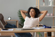 © fizkes - Happy african girl student relaxing finished study sit at desk