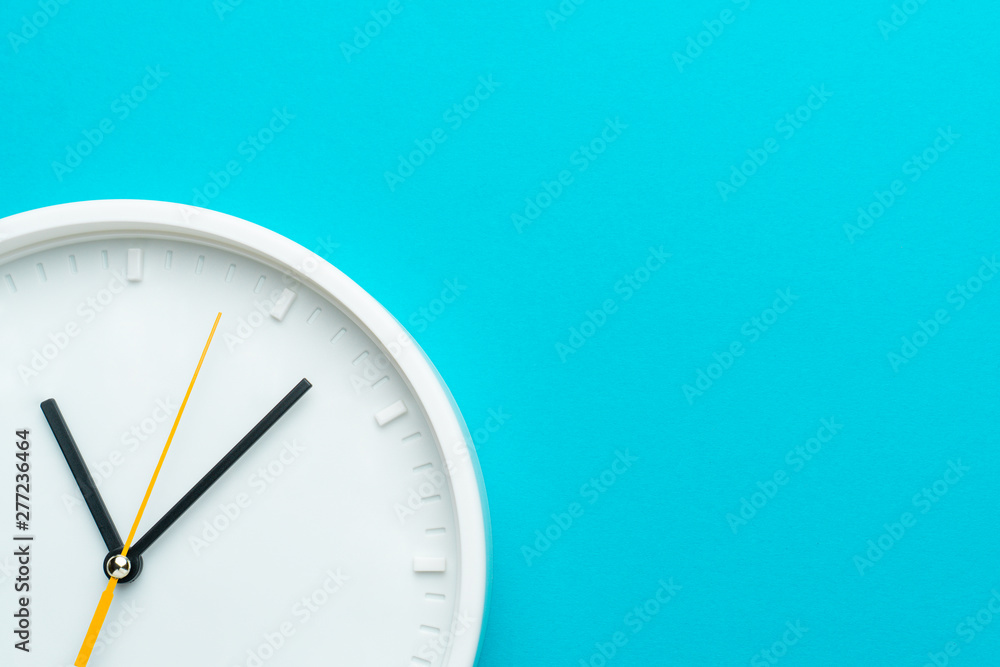 Part of white wall clock with yellow second hand hanging on wall. Close up image of plastic wall clock over turquiose blue background with copy space. Photo of time management or time is going concept - obrazy, fototapety, plakaty 