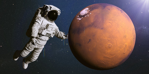 Wall Mural - astronaut holding the red planet mars