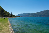 Fototapeta Mosty linowy / wiszący - Lago Di Garda coastline, Italy. Promenade path along the lake
