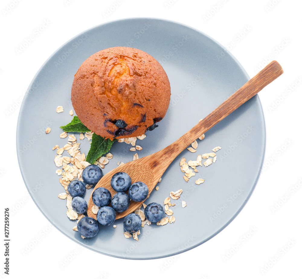 Plate with tasty blueberry muffin on white background