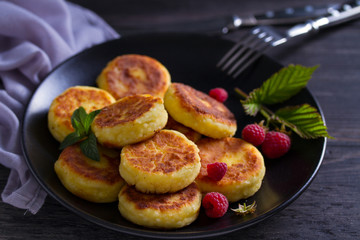 Wall Mural - Cottage cheese pancakes. Syrniki and raspberries