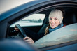 © lightpoet - Woman driving a car - female driver at a wheel of a modern car, looking happy, smiling with a relaxed smile (shallow DOF; color toned image)