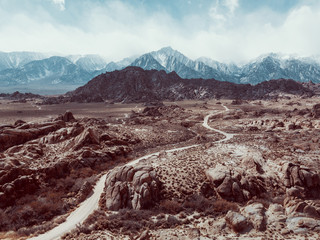 Wall Mural - Alabama hills seen from above, with a dirty road. Mountains in the background. blue sky and desert view