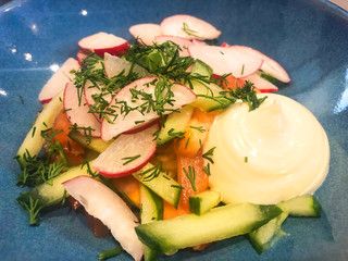 Canvas Print - Fresh vegetable salad on blue plate.