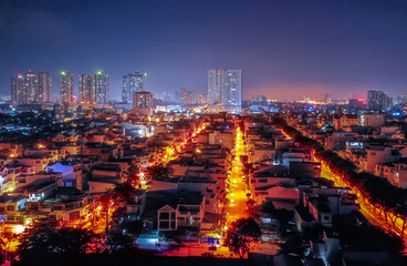 Wall Mural - looking to Sunrise City. Midnight Drone Flight Photo Suburban Ho Chi Minh City