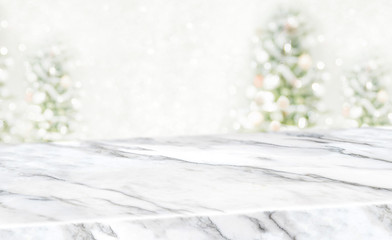 Leinwandbilder - christams blur background,White marble table top at blur bokeh christmas tree decor with string light background when show falling,Winter holiday greeting card