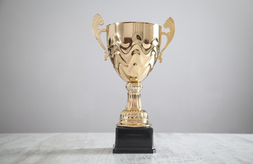 golden trophy on white desk. business, success