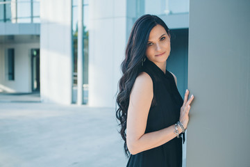 portrait of a beautiful girl near the columns of the theater or Museum