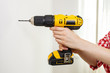 © Voyagerix - Hand holding yellow drill